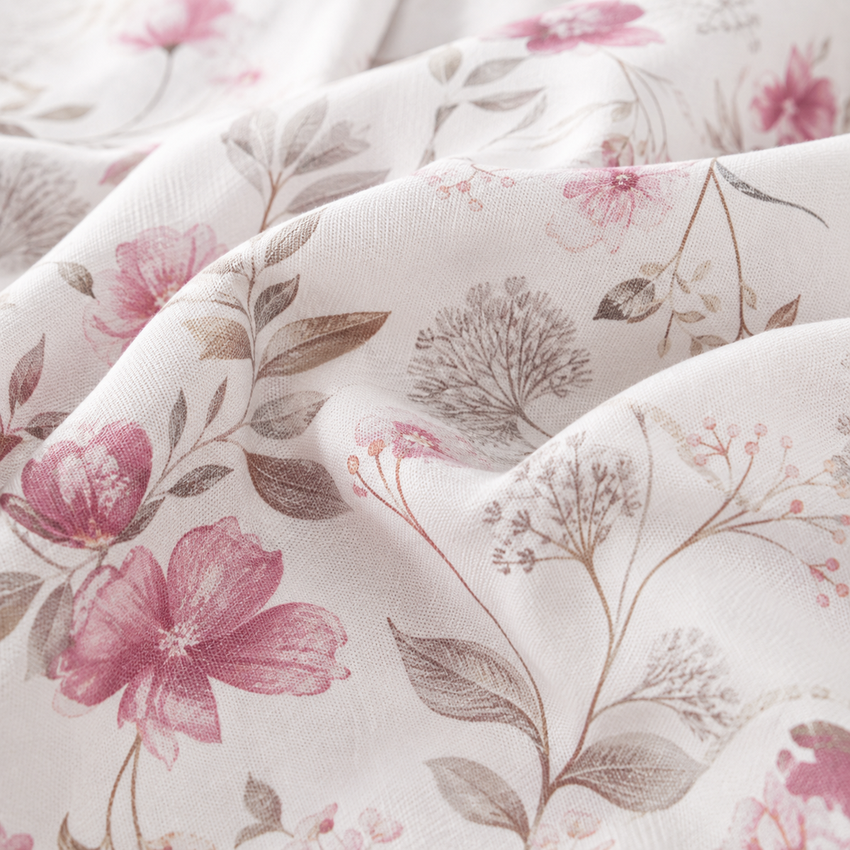 Floral bedding set on a bed in a bedroom with nightstands and a lamp.