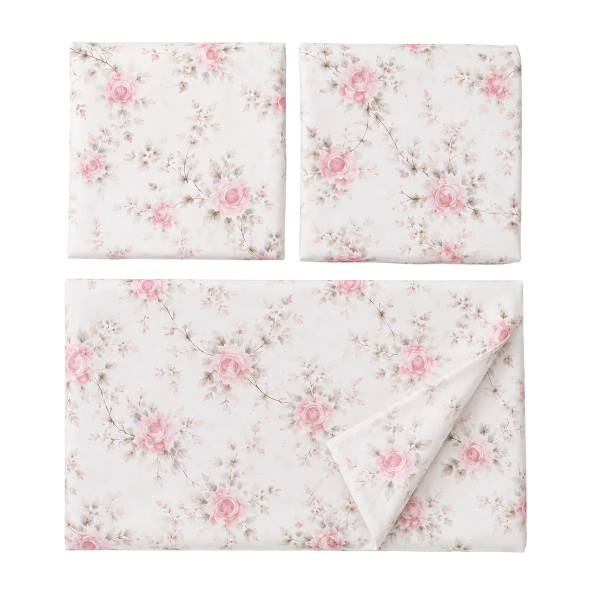 Floral bedding set on a bed with matching pillows in a bedroom setting.