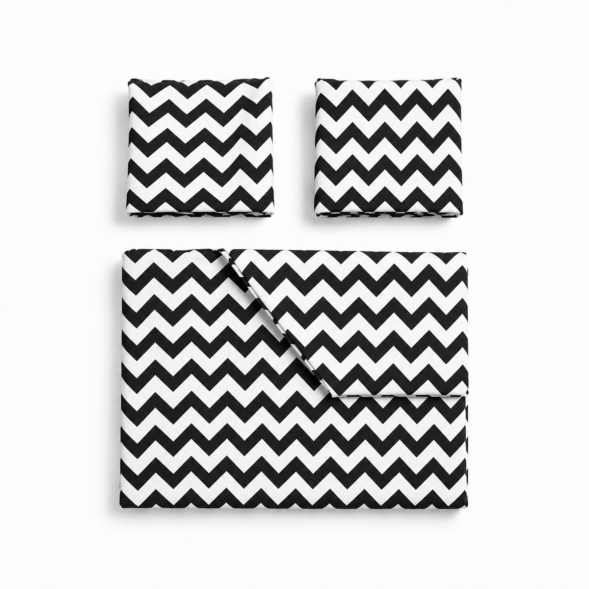 Bed with black and white zigzag patterned bedding in a bright bedroom.