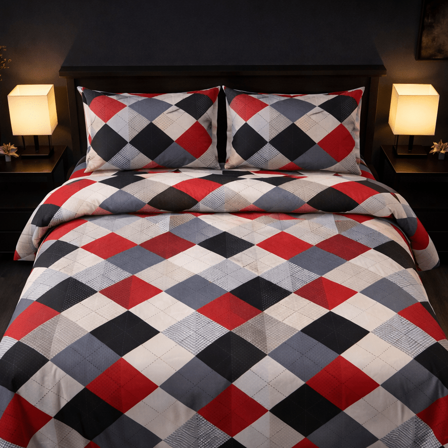 Checkered bedspread with red, blue, and white pattern on a bed in a dimly lit room.