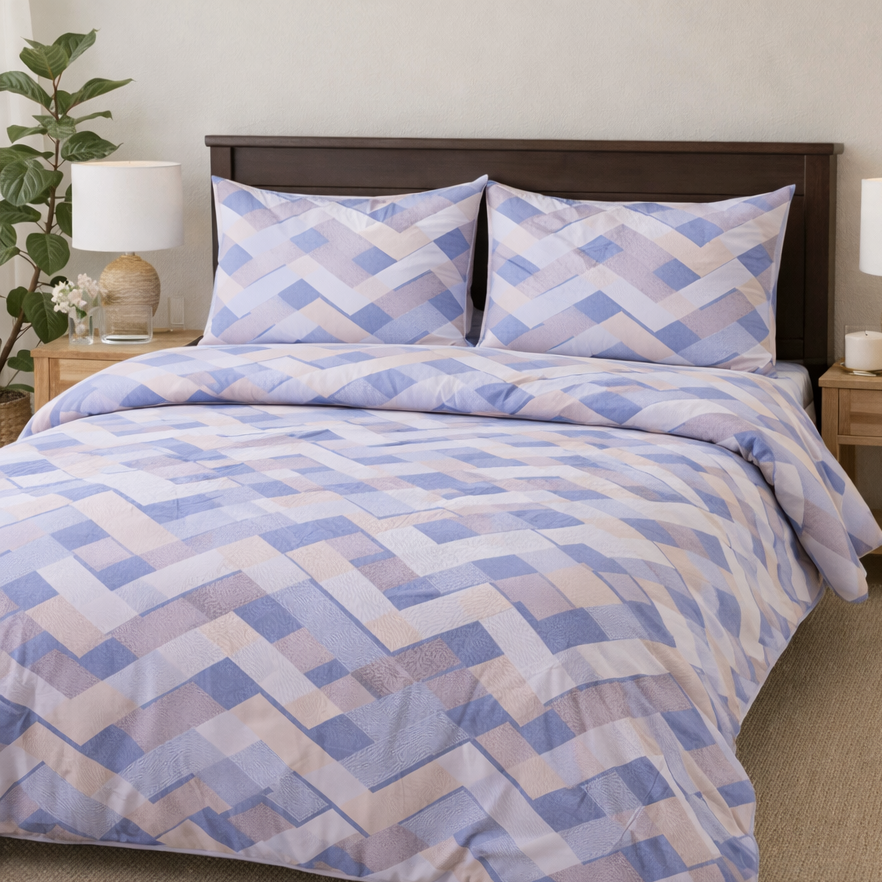 Bed with blue and white geometric patterned bedding in a bright bedroom.