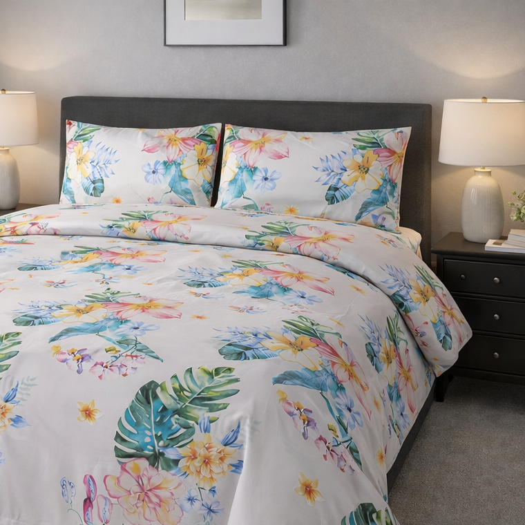 Floral comforter set on a bed in a bedroom with lamps and nightstands.