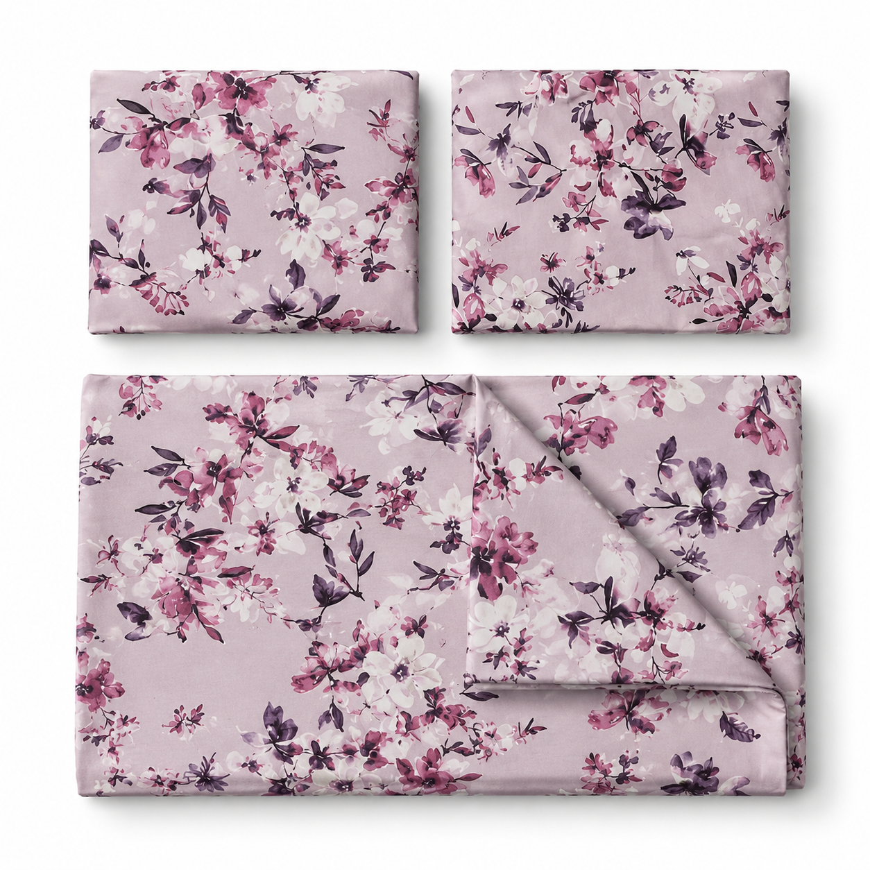 Three folded fabric pieces with a floral print in dusty pink, white, and dark purple, arranged on a clean white background.