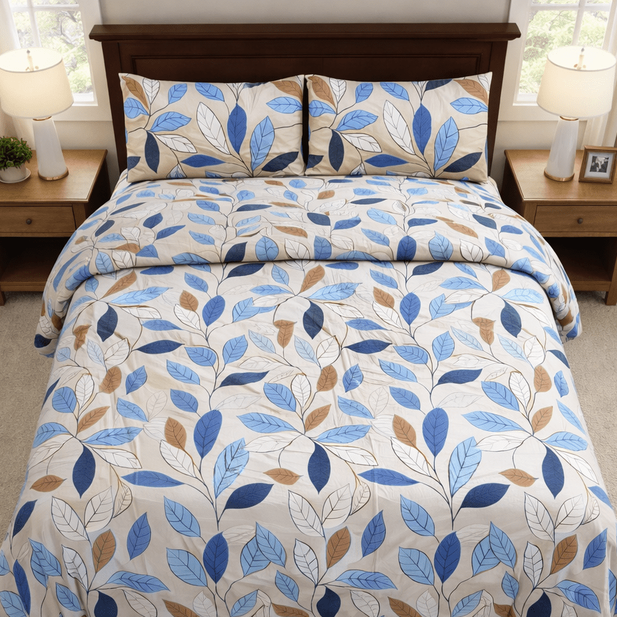 Bed with blue and brown leaf patterned bedding in a bedroom setting.
