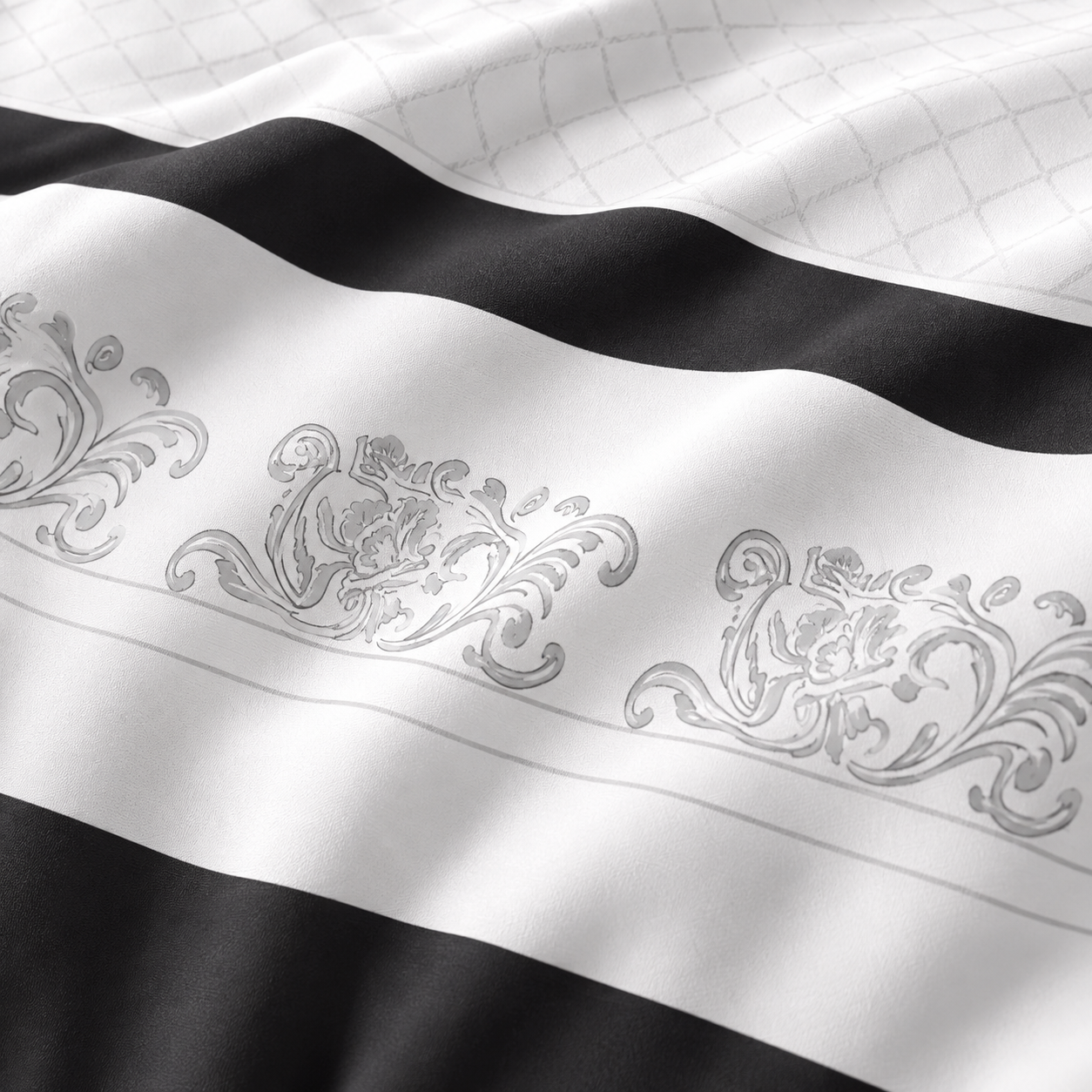 Black and white bedding set on a bed with lamps and decor in the background.