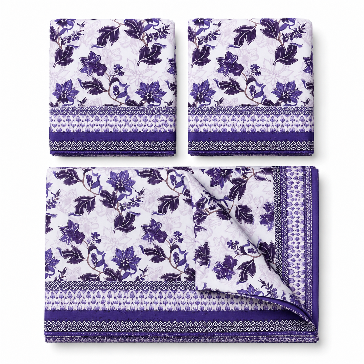 Floral patterned bedding set on a bed with matching pillows, against a white wall with a framed picture.