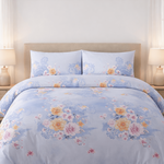 Floral patterned comforter set on a bed in a well-lit bedroom.
