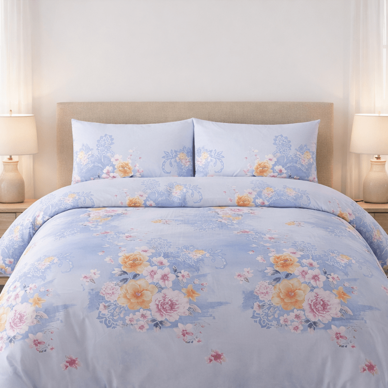 Floral patterned comforter set on a bed in a well-lit bedroom.