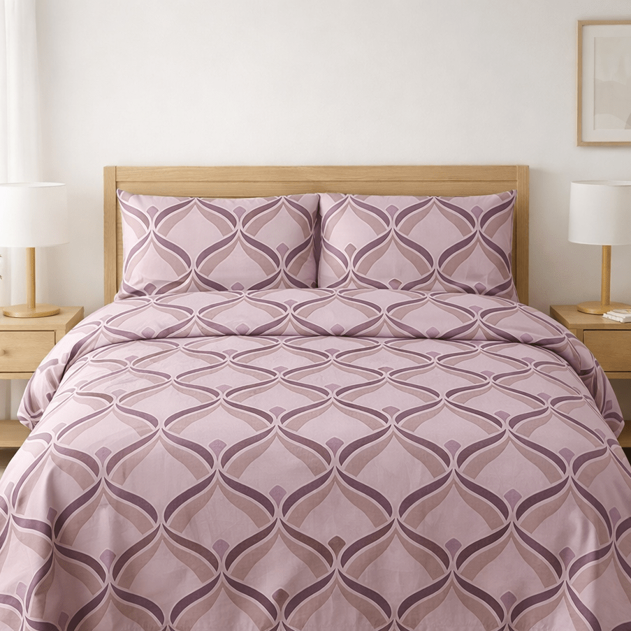 Bed with purple patterned bedding in a bedroom setting