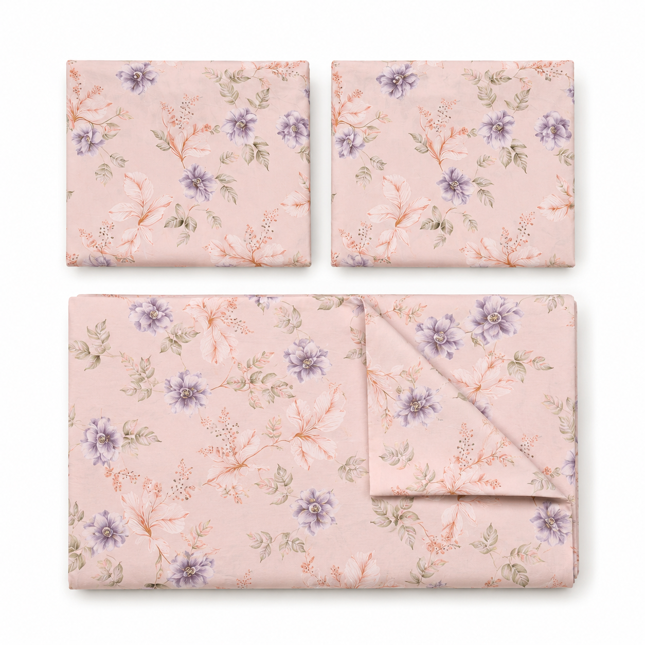Floral patterned bedding set on a bed with matching pillows in a bedroom setting.