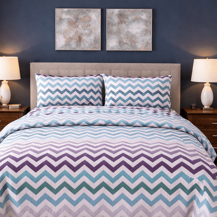 Bedroom with a bed featuring a chevron patterned comforter, two nightstands with lamps, and framed artwork on the wall.