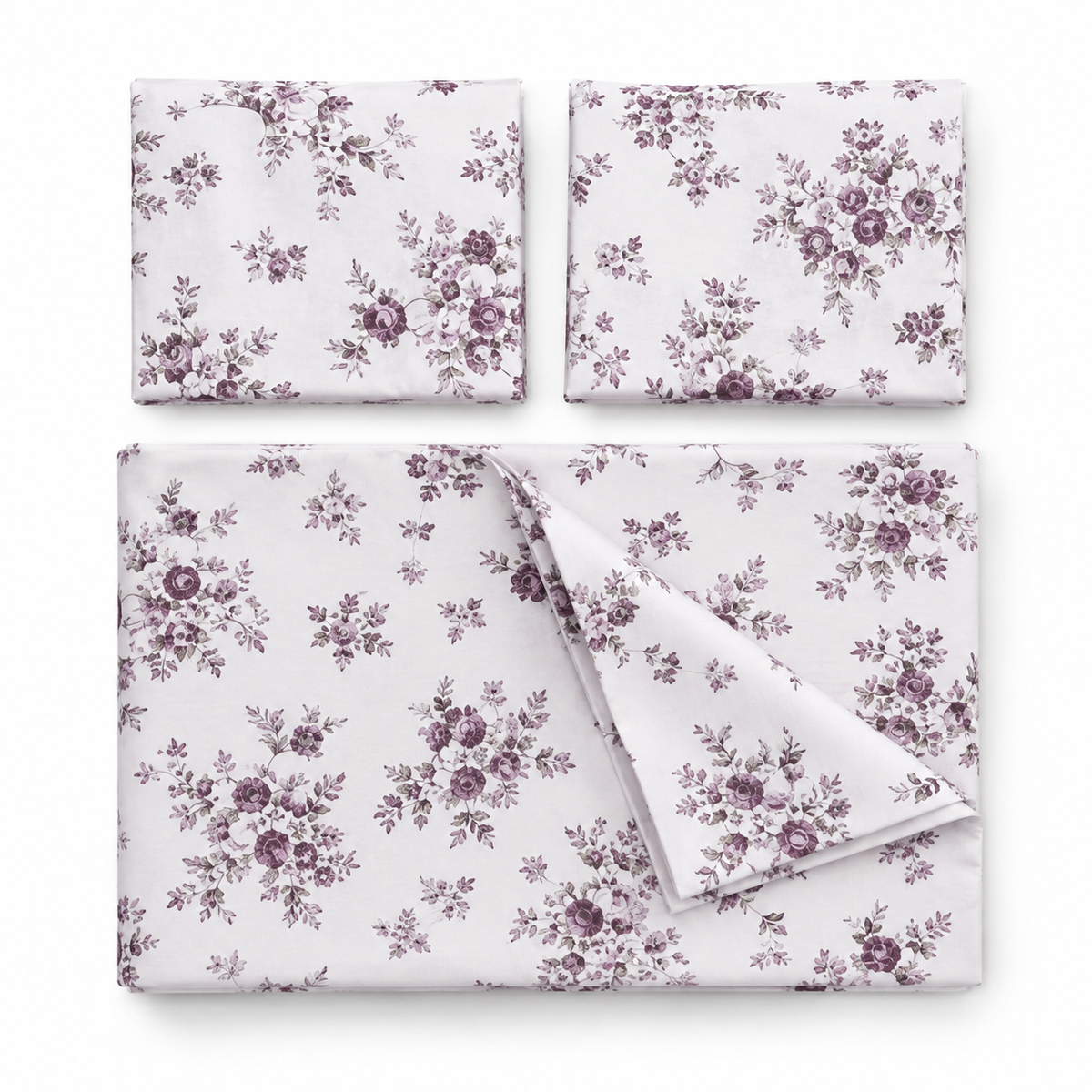 Floral bedding set on a bed with matching pillows in a bedroom setting.