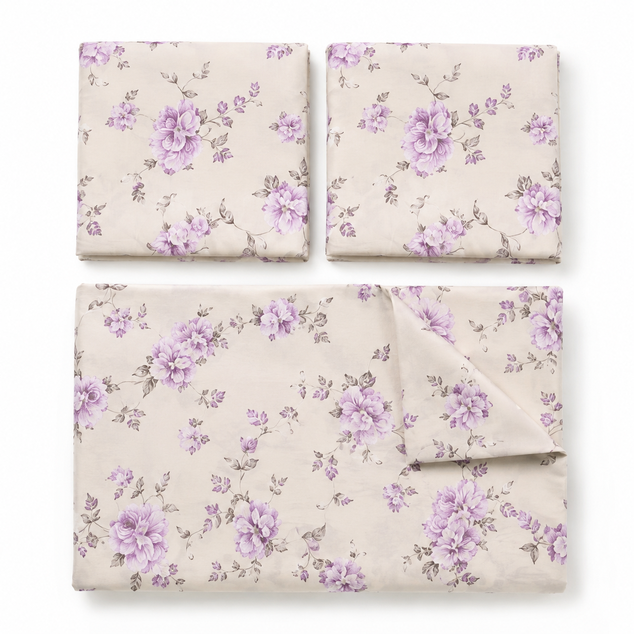 Floral bedding set on a bed in a bedroom with framed artwork on the wall.
