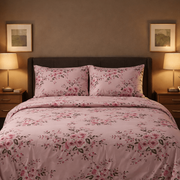 Floral bedding set on a bed in a bedroom with lamps and artwork.