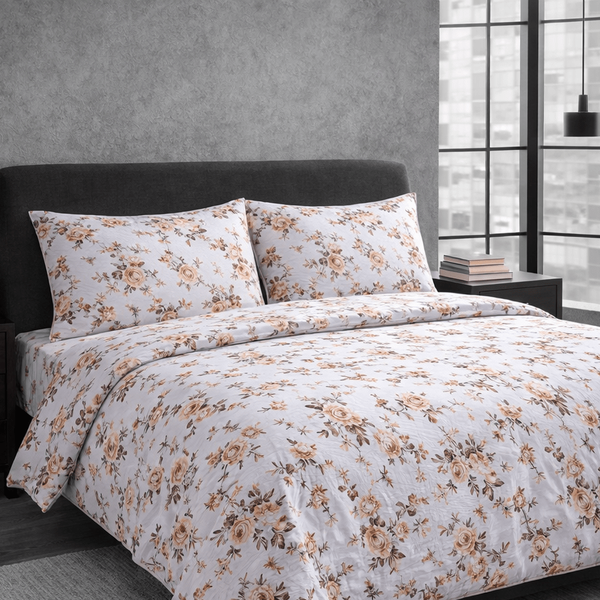 Floral patterned bedding set on a bed in a bedroom with a gray wall and window.