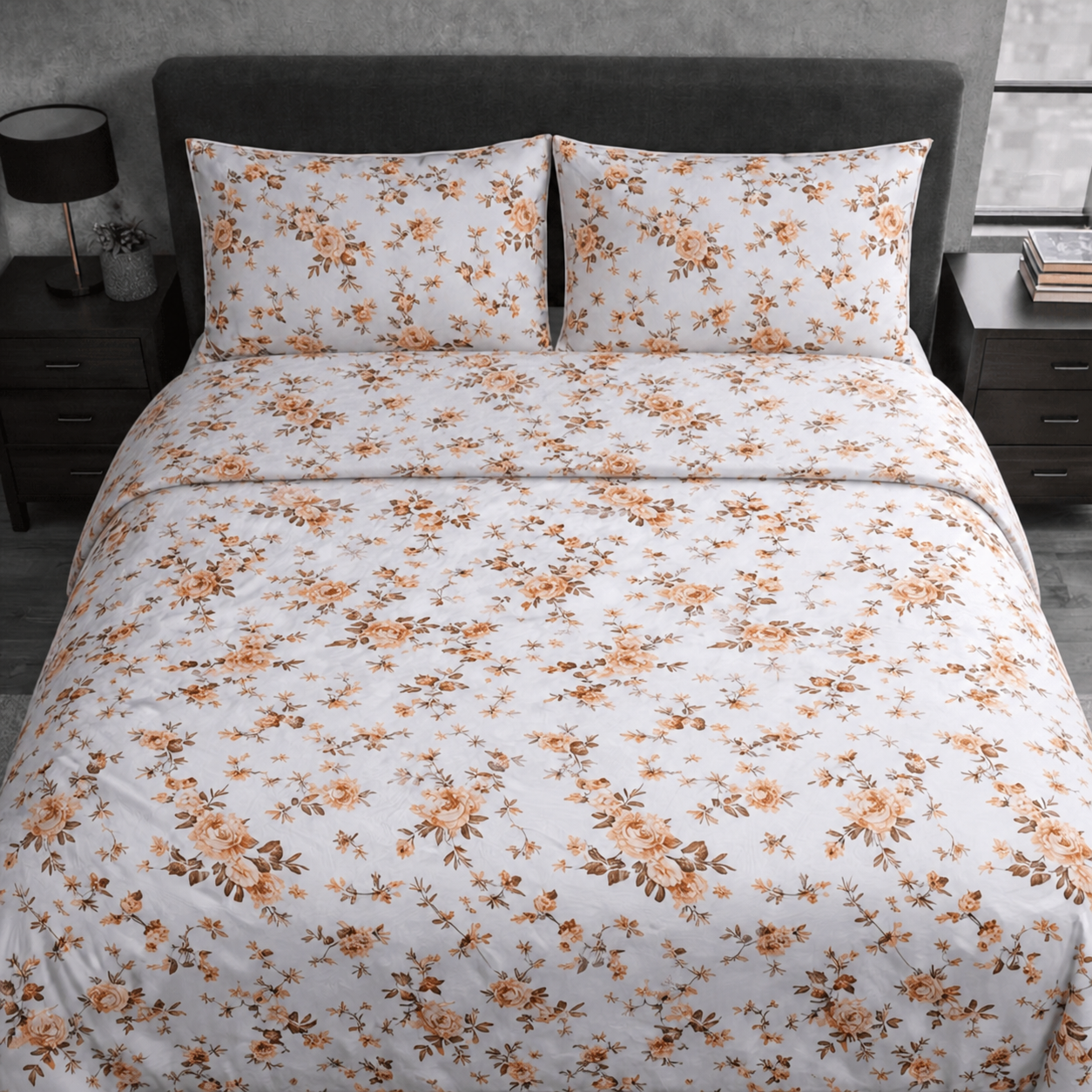 Floral patterned bedding set on a bed with matching pillows.