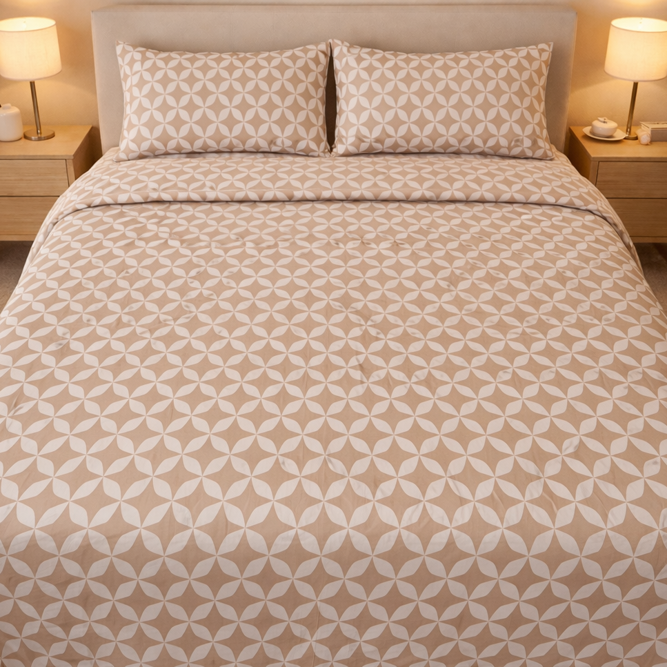 Beige and white patterned bedding set on a bed with matching pillows, in a bedroom setting.