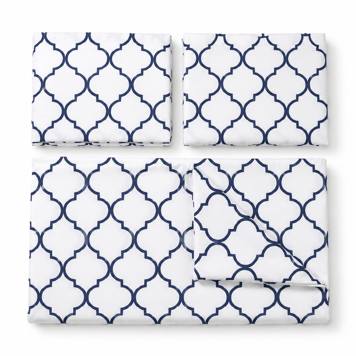 A bedding set with a white background and a navy blue Moroccan trellis pattern, shown in four pieces: two flat sheets, one pillowcase, and one folded sheet on a white background.