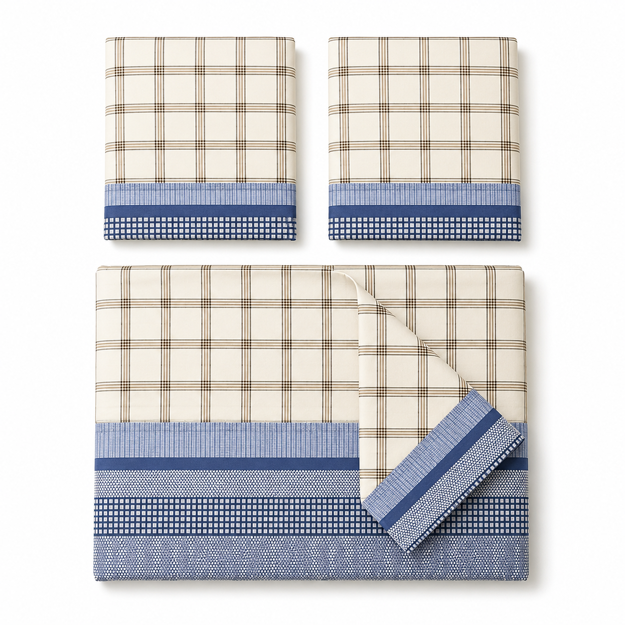 Bed with plaid bedding and pillows against a brick wall.