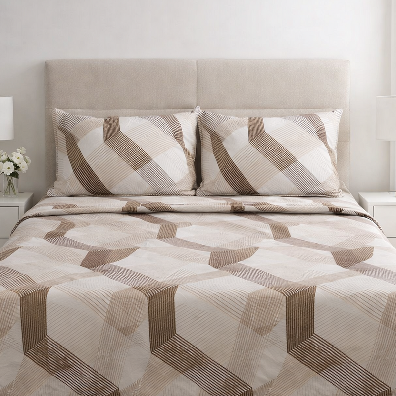 Bed with geometric patterned bedding in a bedroom setting