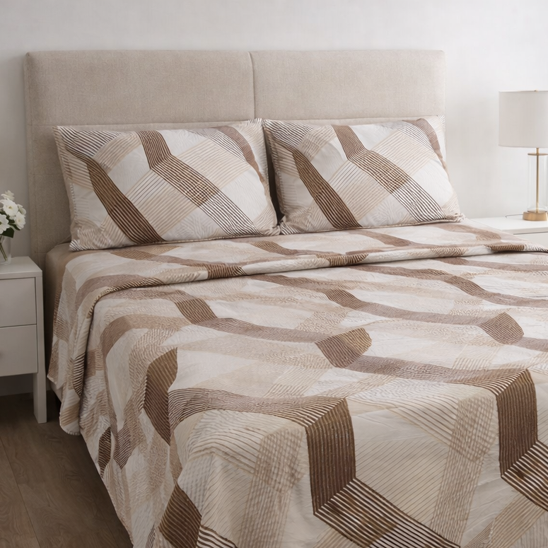 Bed with patterned bedding in a bedroom setting