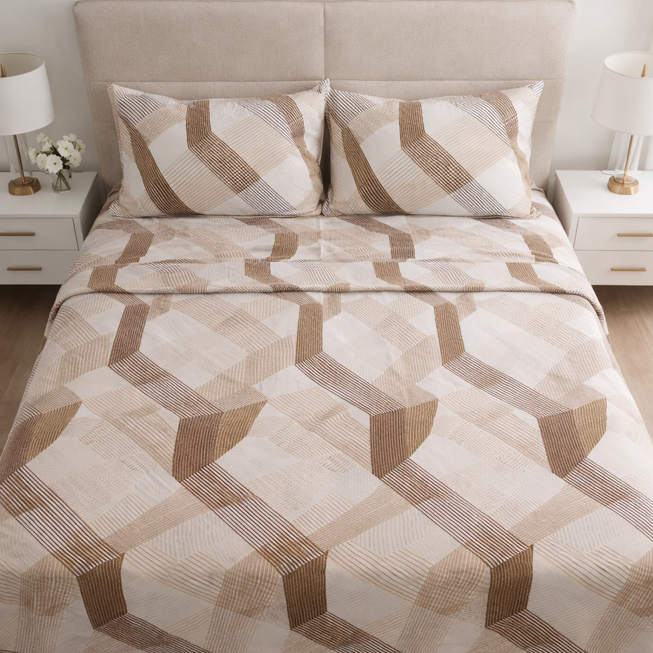 Bed with geometric patterned comforter and pillows in a bedroom setting.