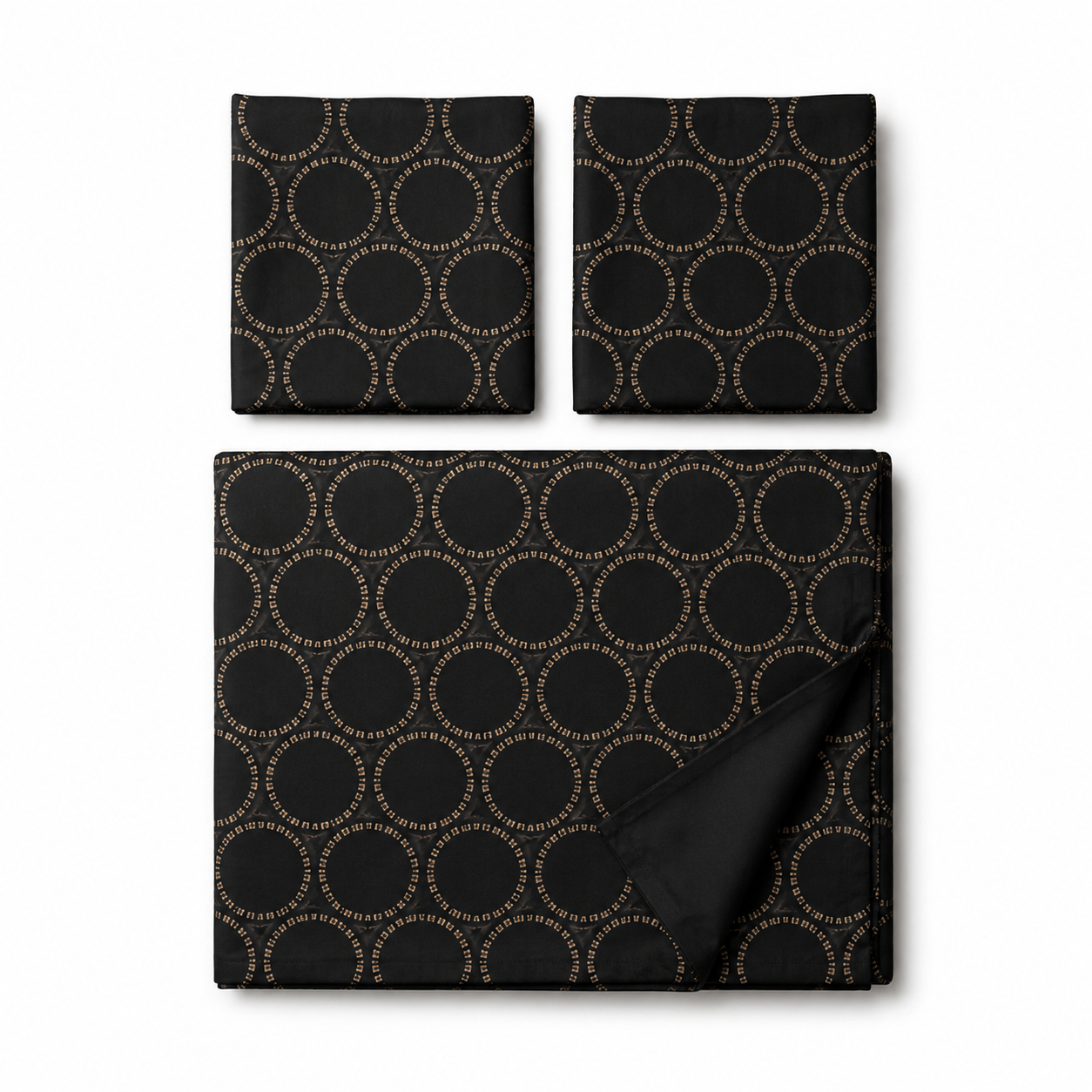 Three-piece black fabric set with a repeating gold circular dot pattern, including a large square piece, a smaller square piece, and a rectangular cloth, displayed on a white background.