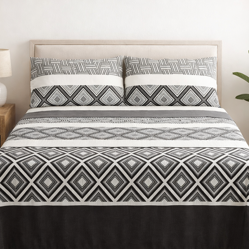 Bed with geometric patterned bedding in a bedroom setting