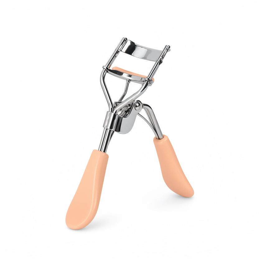 Eyelash curler with peach-colored handles on a white background