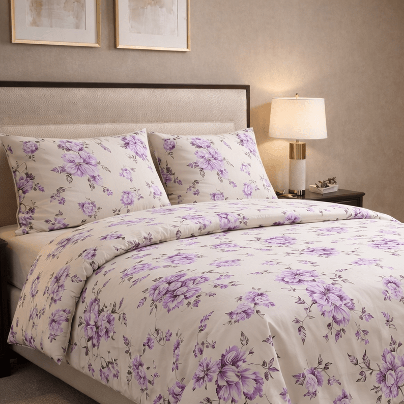 Bed with purple floral bedding in a bedroom setting
